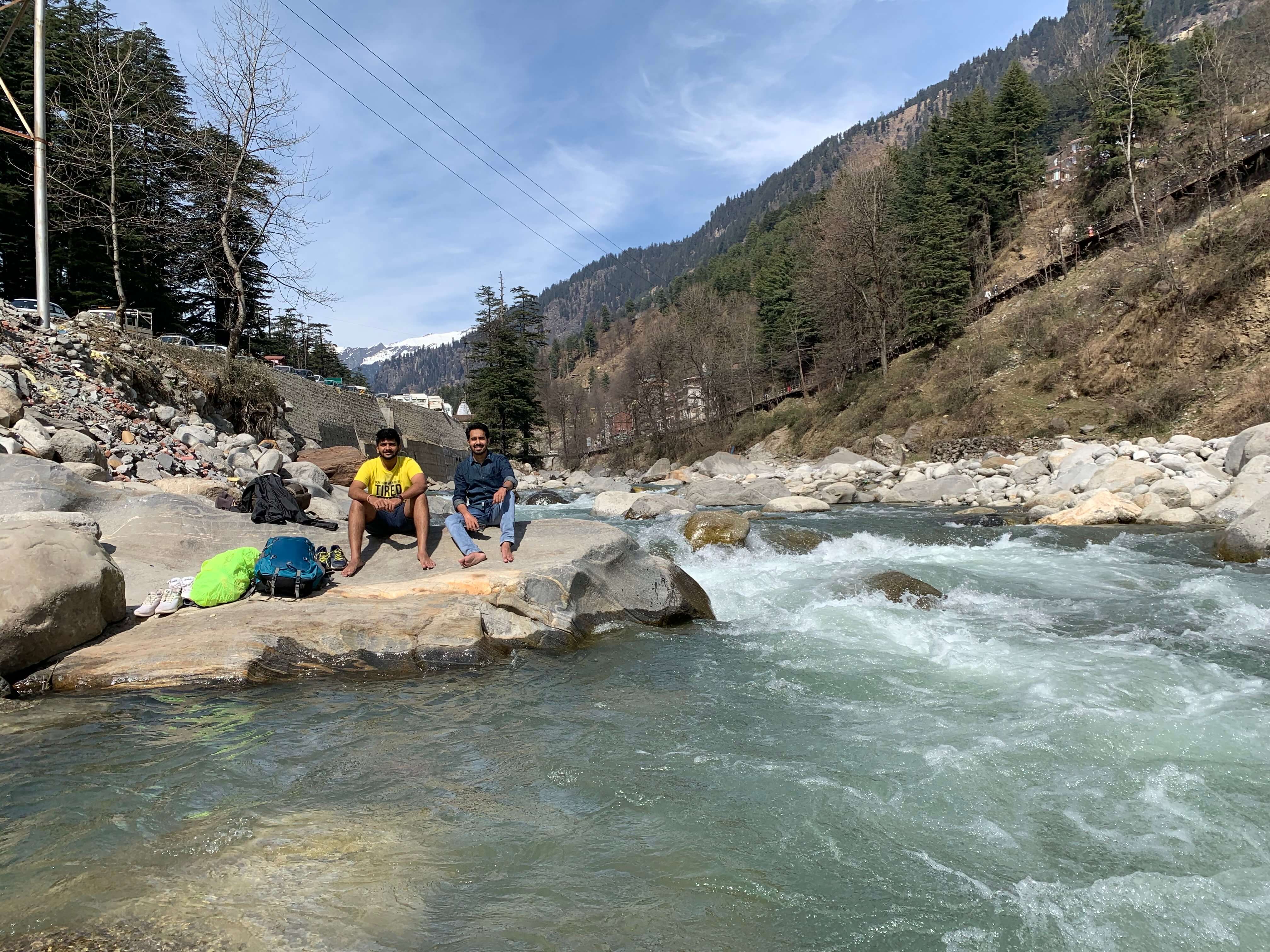 Working on laptop near a river in Manali
